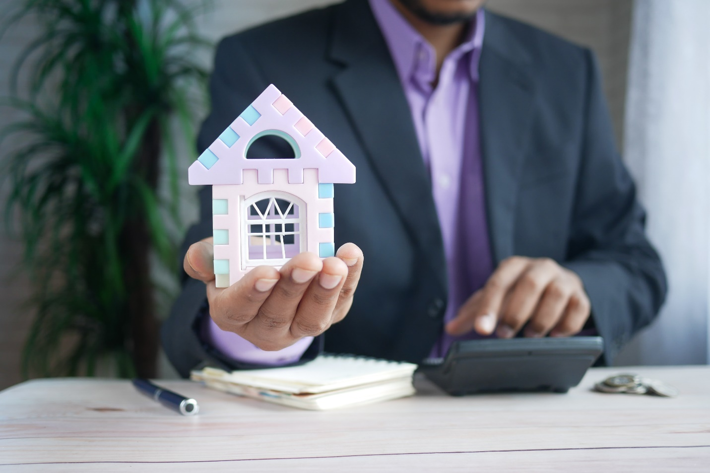 Realtor holding a toy house